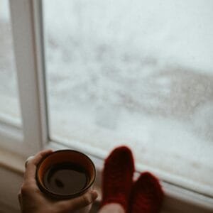 Close-up of Holding a Coffee by the Window