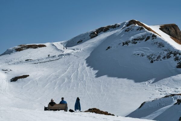 Hikers on a Snow Covered Mountain Slope